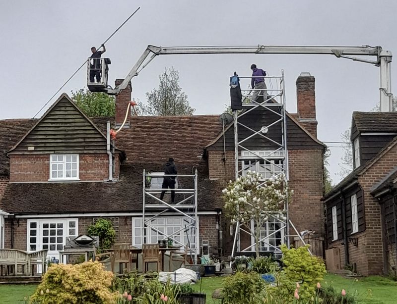 The Roof Moss Cleaners using cherry picker and scaffolding to clean roof safely and professionally in Westergate, West Sussex
