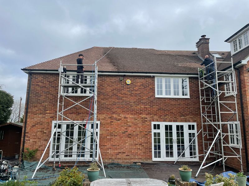Roof cleaning carried out safely from scaffold towers by The Roof Moss Cleaners in Westergate